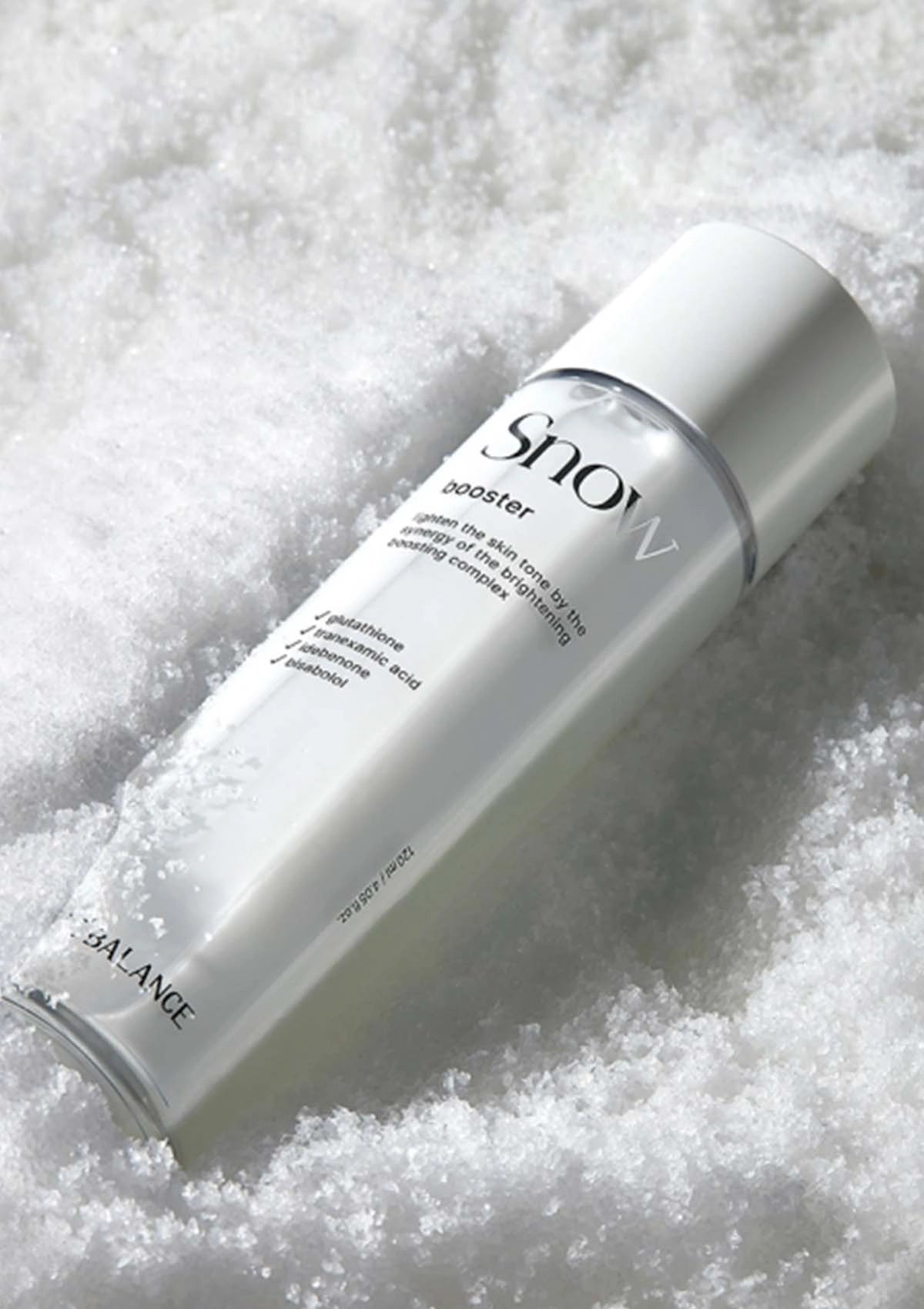 Skincare bottle labeled 'Snow' on a textured white background